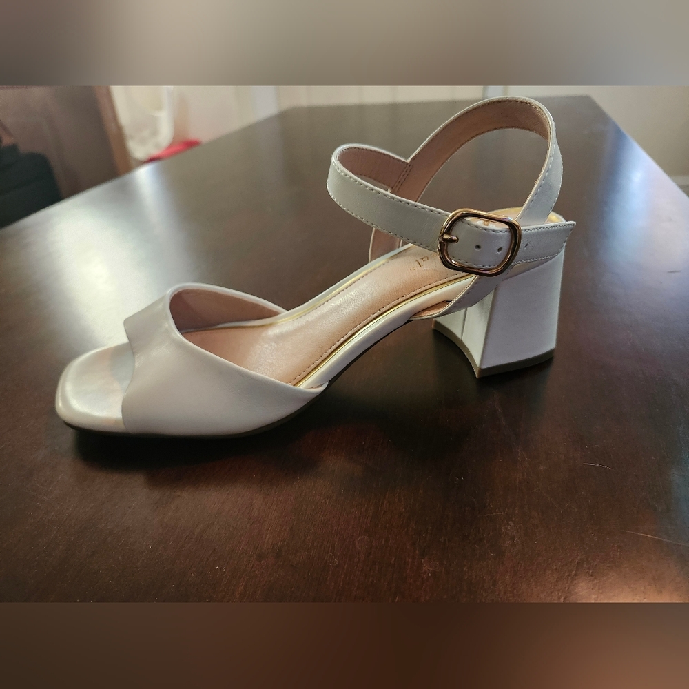 White block heel sandals with tan sole.